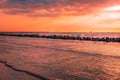 Waves smashing into the breakwater made of rocks in the evening sun. Cloudy sky, windy, summer day at the polish seaside. DarÃâÃÂ³ Royalty Free Stock Photo